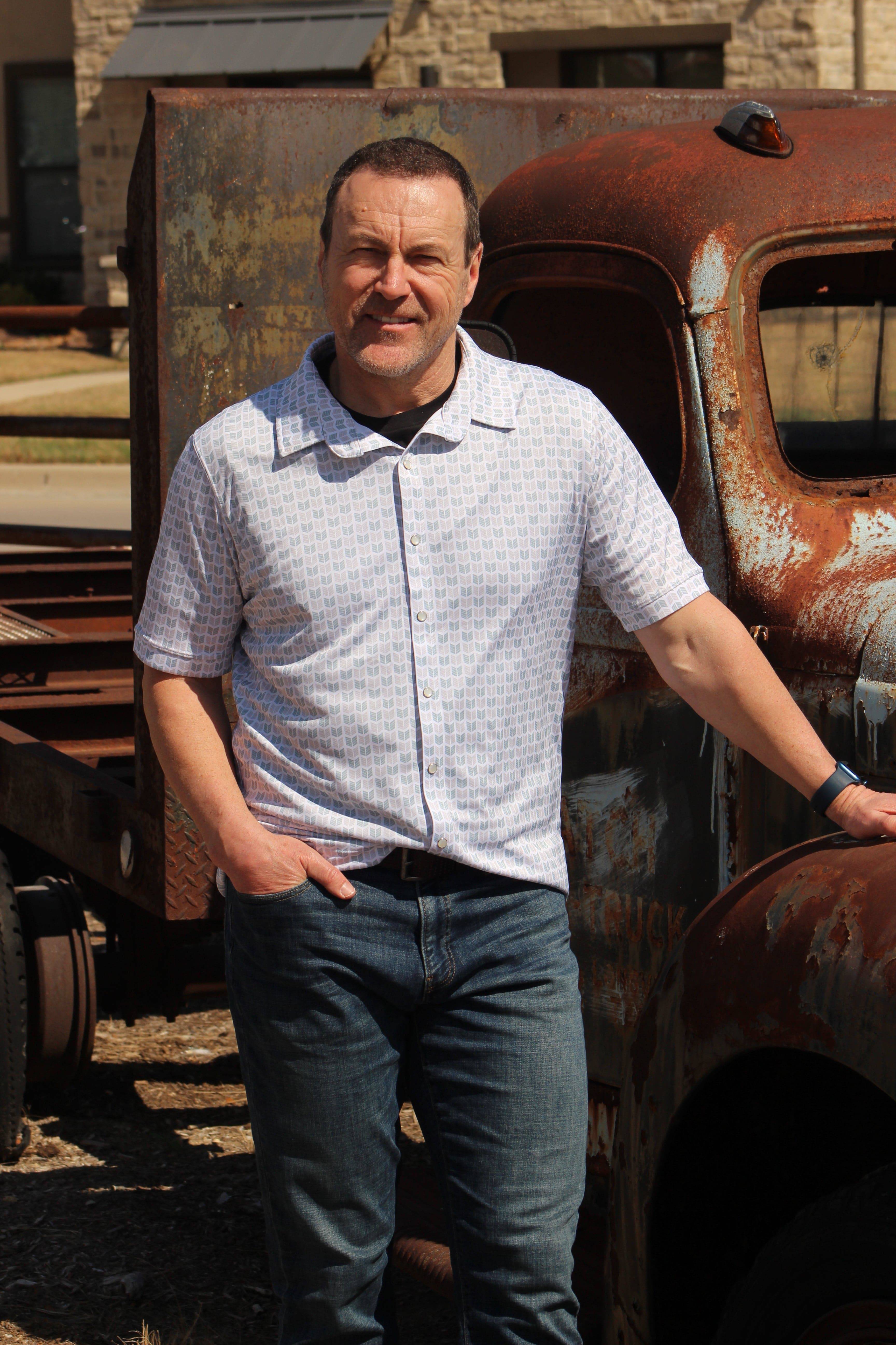 A model showcasing the Howdy-Ho Arctic Sky Arrows shirt, paired with sleek, dark denim jeans. This image highlights the shirt's tailored fit and adaptable style, perfect for achieving a smart, yet relaxed appearance.